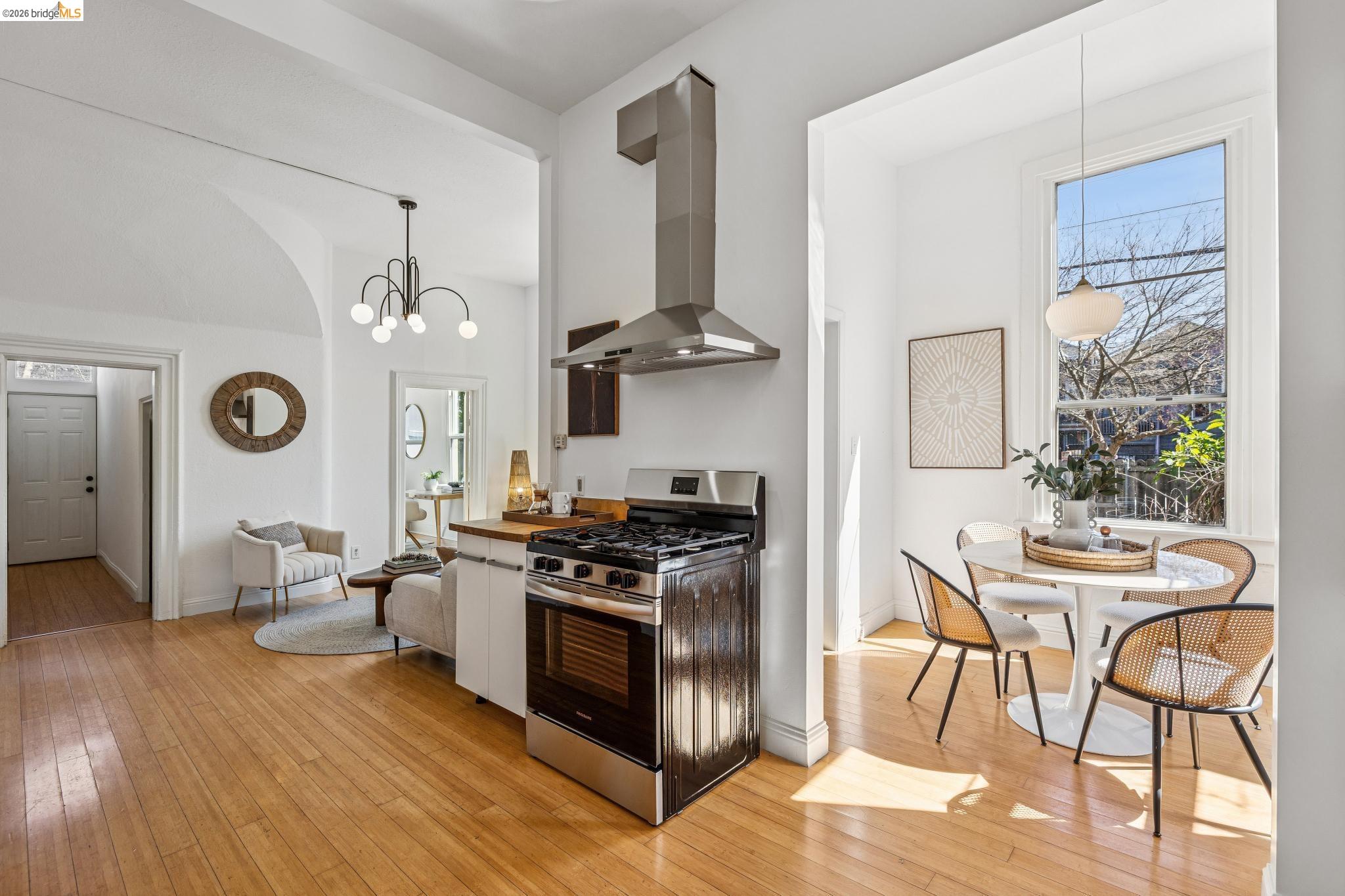 1655 12th Street Oakland, CA 94607 - Photo 9 of 51 a kitchen with stainless steel appliances a stove a table and chairs in it