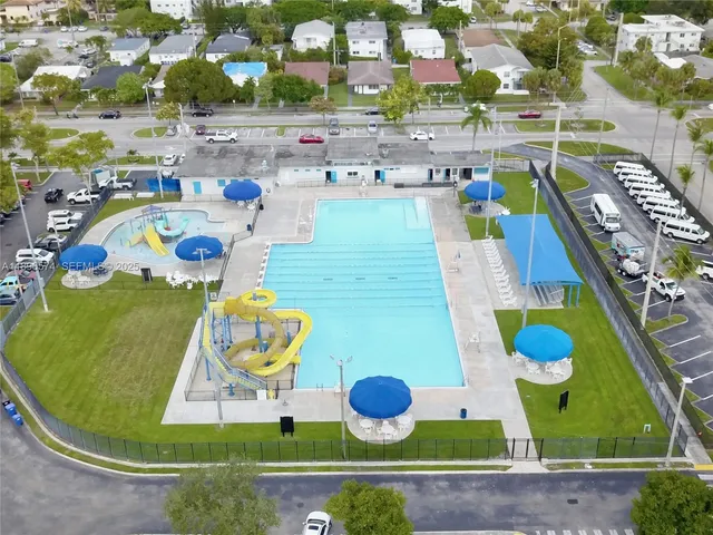 a room with lots of white furniture and painting on the wall