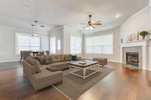 a living room with furniture a fireplace and a chandelier