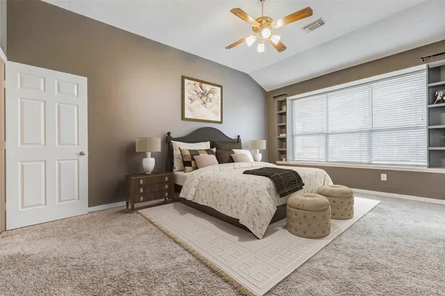 a bedroom with a bed and a large window