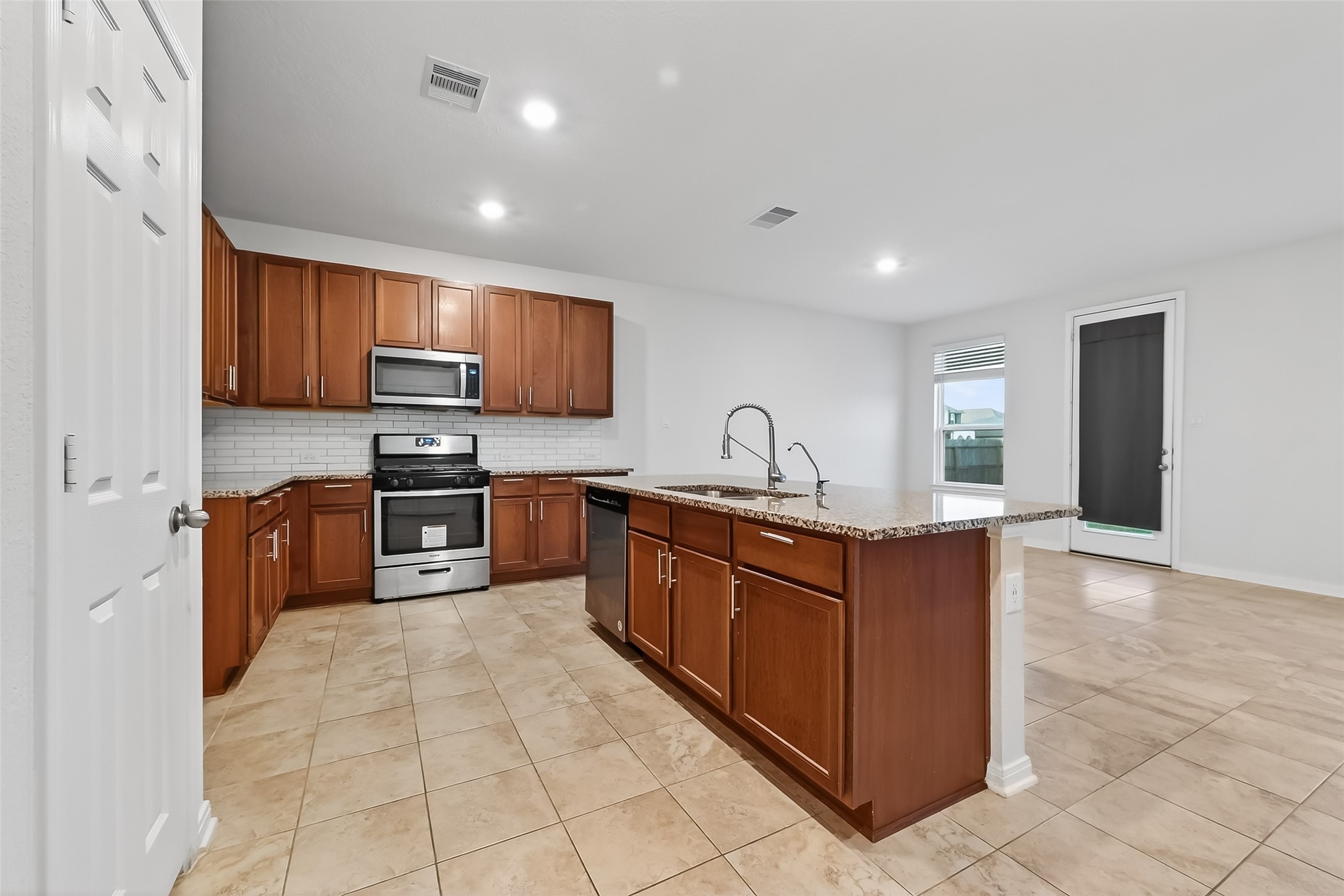 5907 Osprey Drive Rosenberg, TX 77469 - Photo 7 of 36 a large kitchen with stainless steel appliances and cabinets