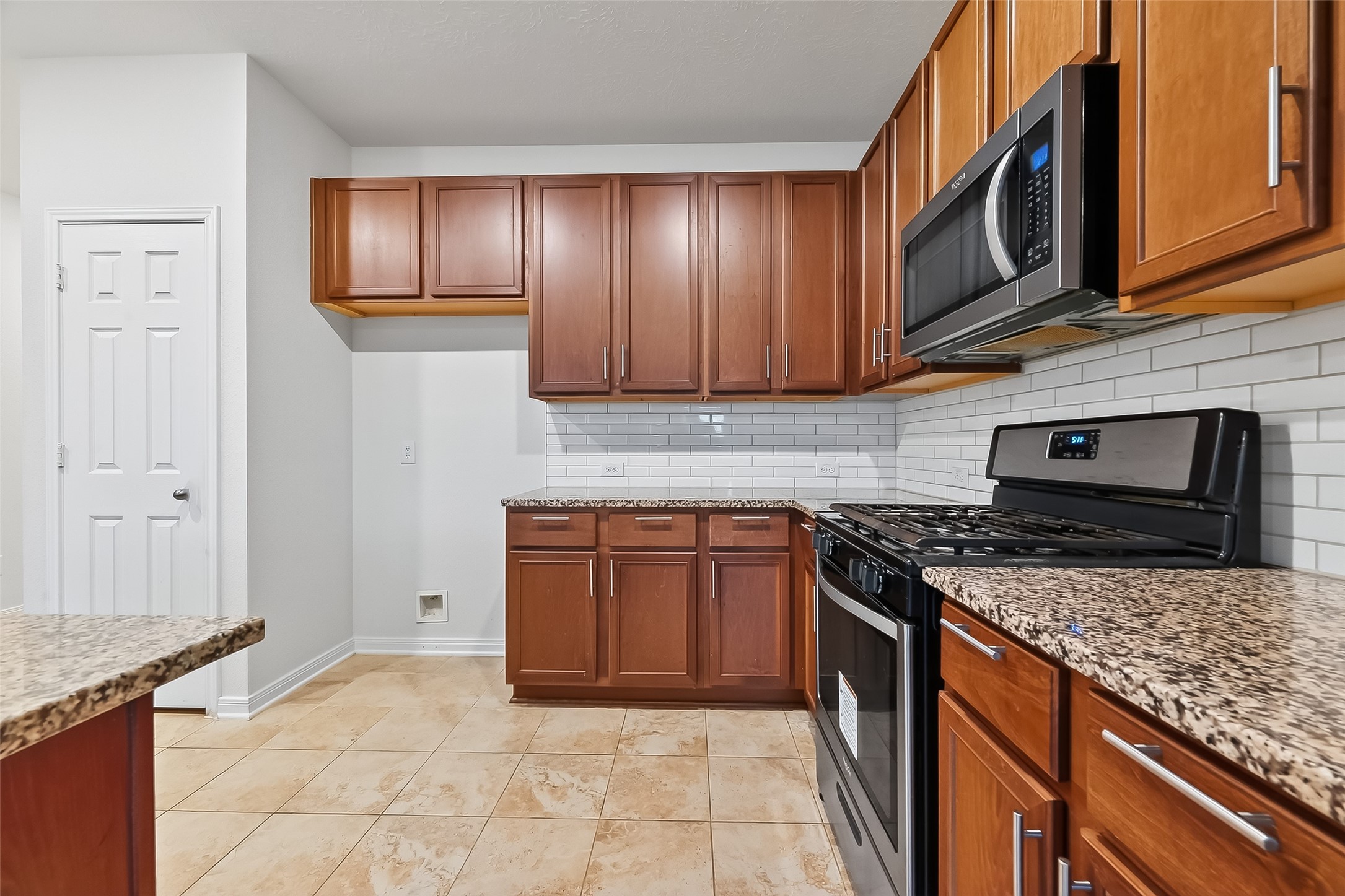 5907 Osprey Drive Rosenberg, TX 77469 - Photo 9 of 36 a kitchen with stainless steel appliances granite countertop a stove top oven microwave and cabinets