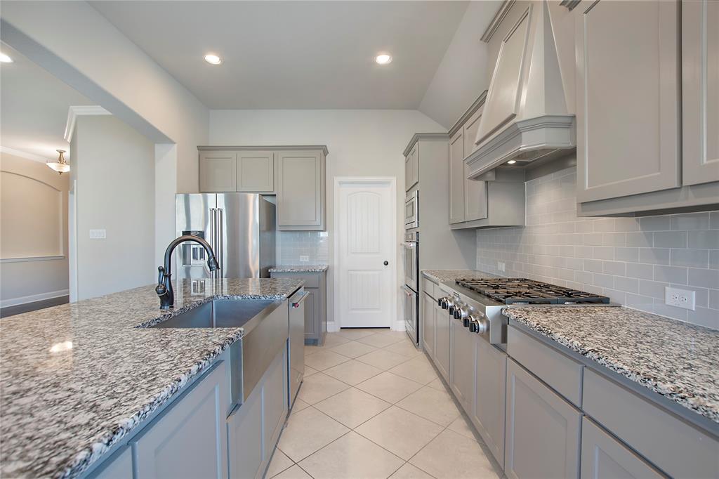 2811 Diamond Ridge Drive Arlington, TX 76001 - Photo 14 of 35 a kitchen with stainless steel appliances granite countertop a sink a stove and a refrigerator