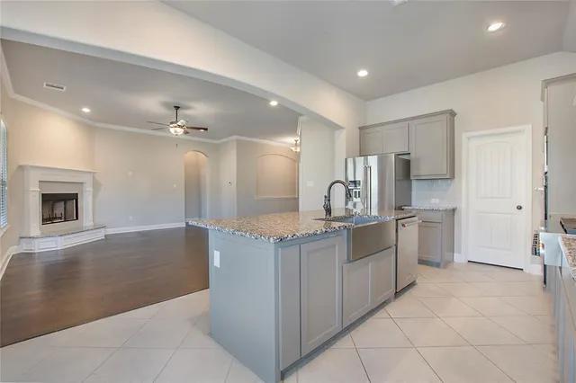 a view of an empty room with a window and chandelier