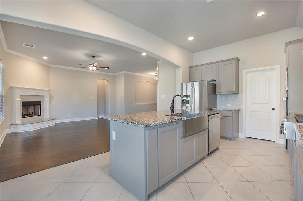 2811 Diamond Ridge Drive Arlington, TX 76001 - Photo 15 of 35 a kitchen with stainless steel appliances granite countertop a sink and a refrigerator