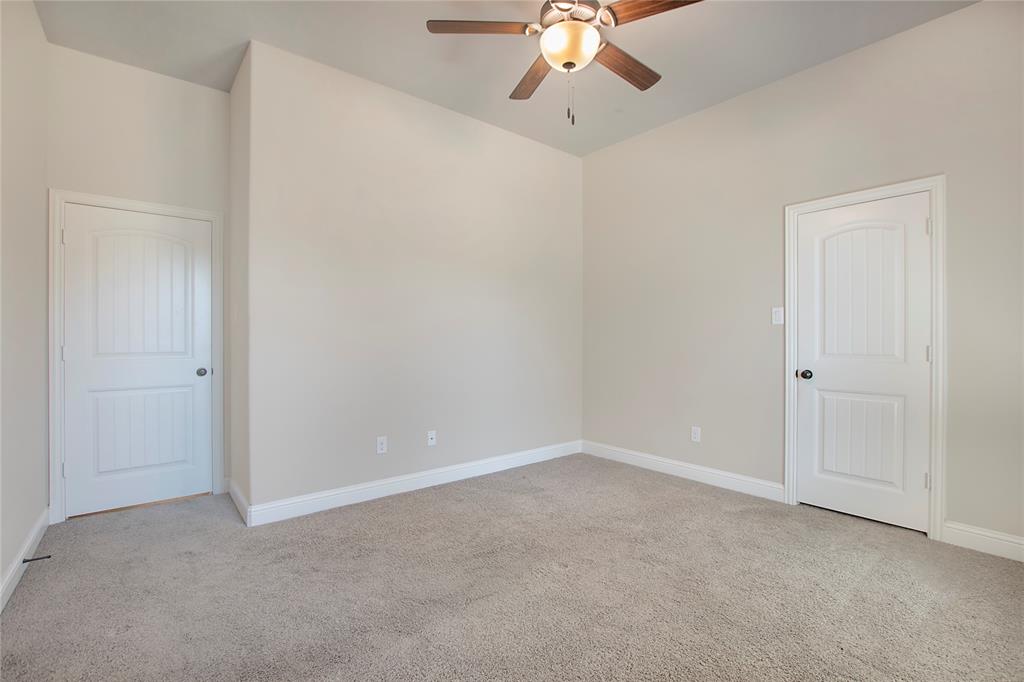 2811 Diamond Ridge Drive Arlington, TX 76001 - Photo 19 of 35 a view of an empty room with a chandelier fan