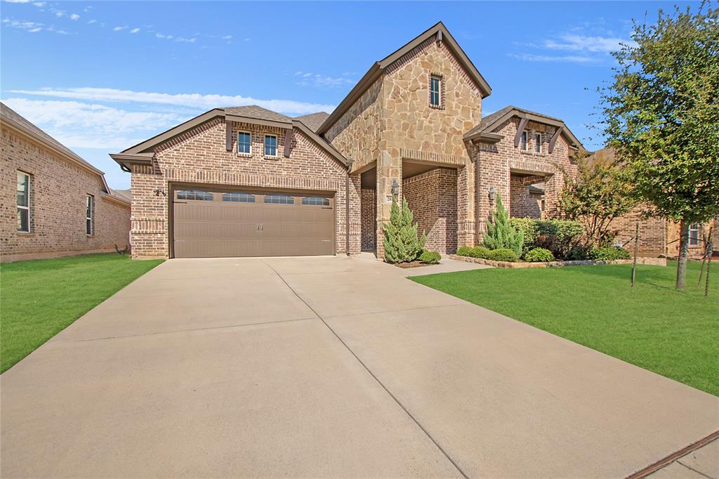 2811 Diamond Ridge Drive Arlington, TX 76001 - Photo 2 of 35 a front view of a house with a yard and garage