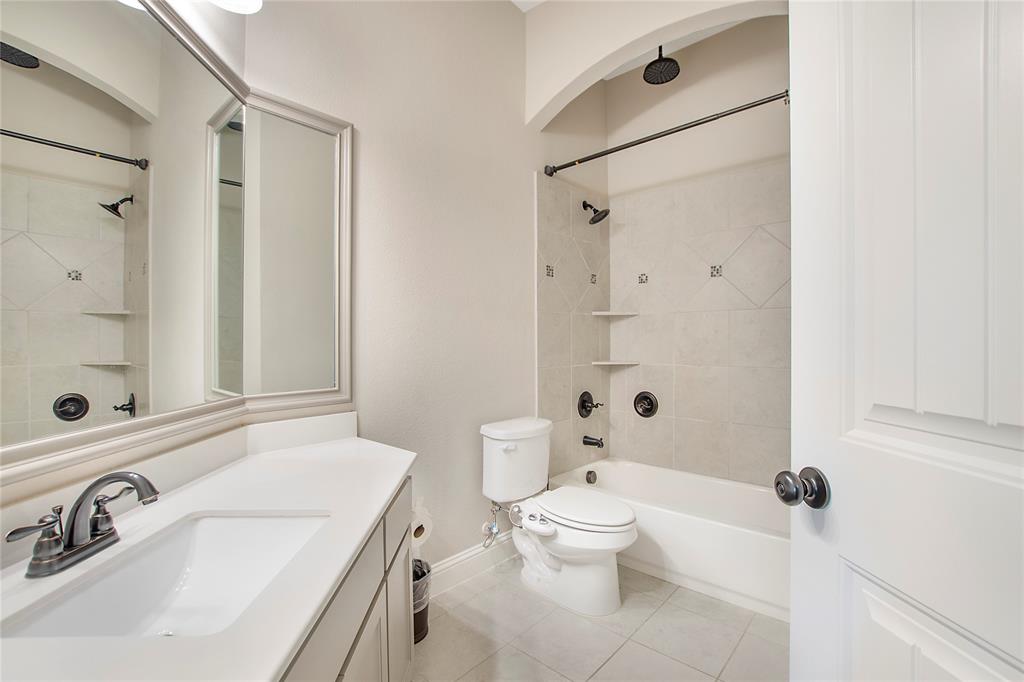2811 Diamond Ridge Drive Arlington, TX 76001 - Photo 22 of 35 a bathroom with a sink a toilet and shower
