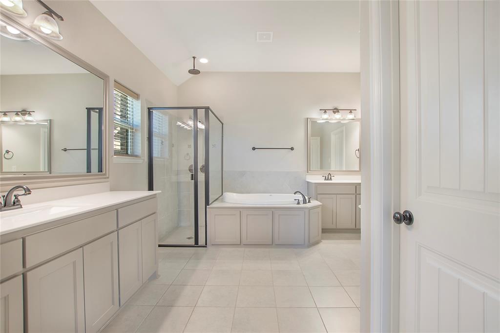 2811 Diamond Ridge Drive Arlington, TX 76001 - Photo 25 of 35 a bathroom with a tub sink shower and mirror