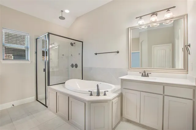a bathroom with a double vanity sink mirror and shower