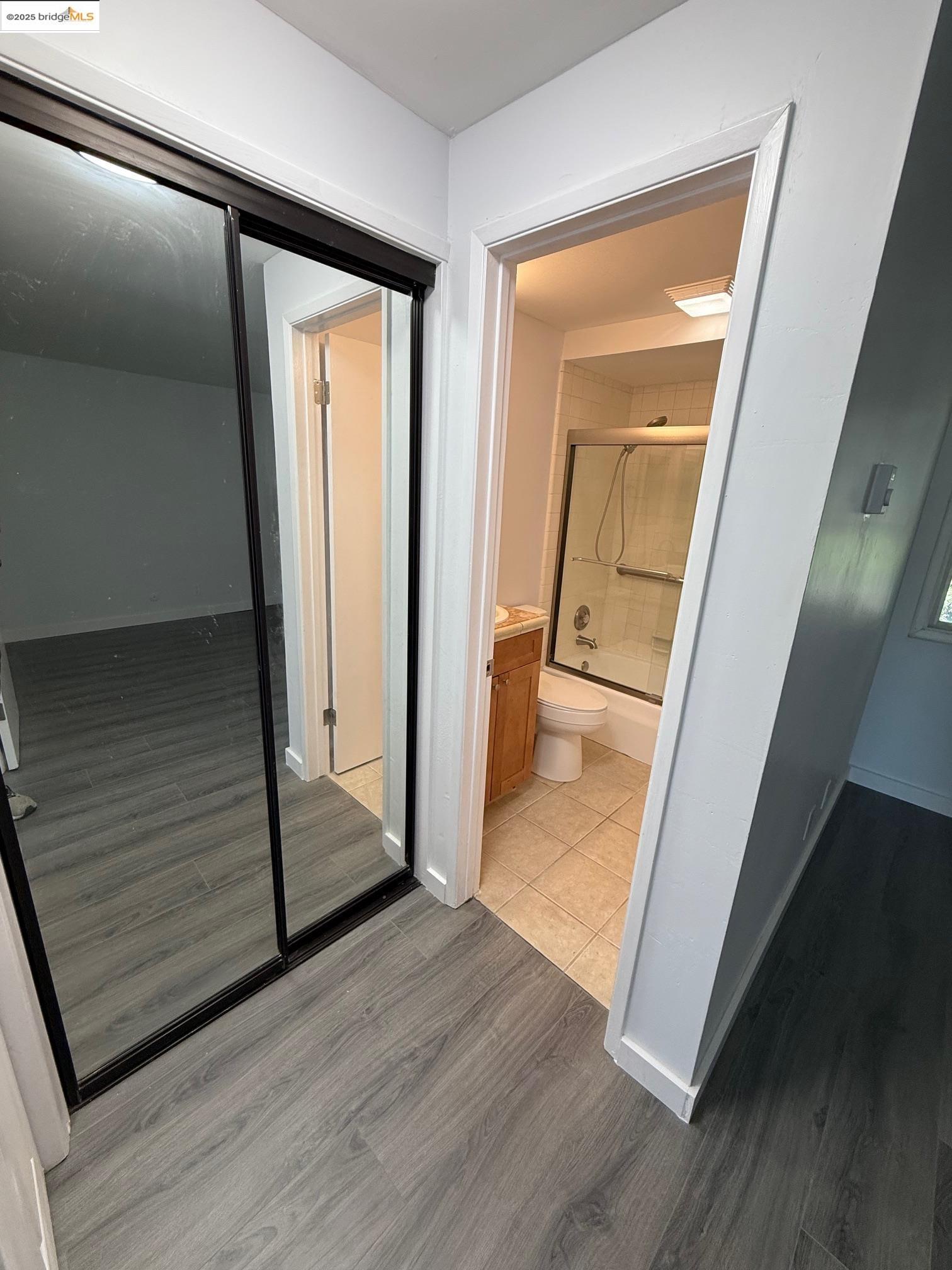 4057 Brant Street, Unit 8 San Diego, CA 92103 - Photo 13 of 17 a view of a hallway with wooden floor and staircase
