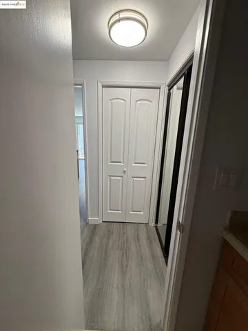 a view of a hallway with wooden floor