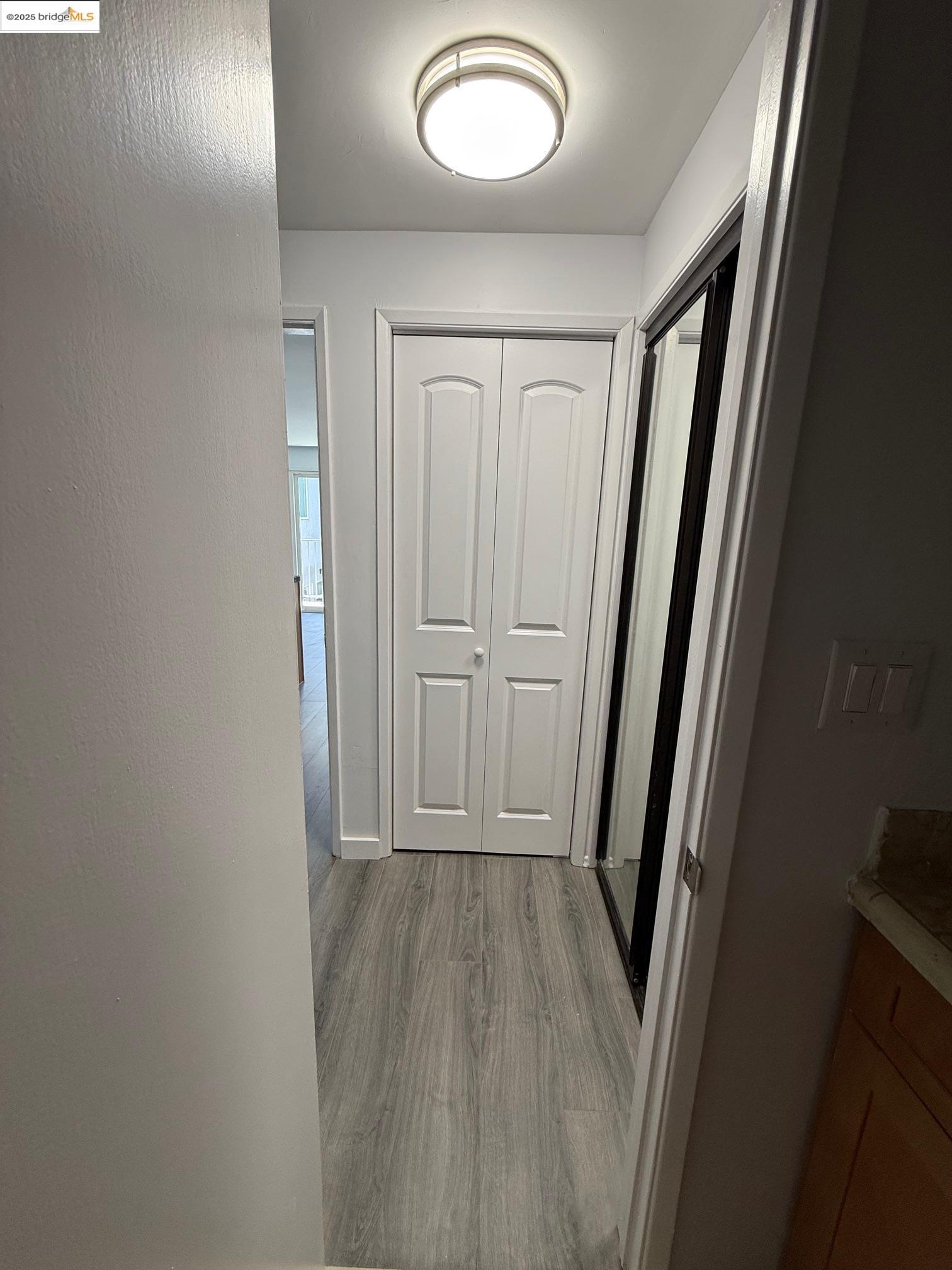 4057 Brant Street, Unit 8 San Diego, CA 92103 - Photo 15 of 17 a view of a hallway with wooden floor