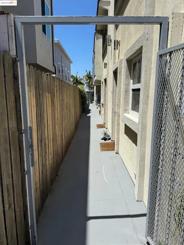 a view of staircase with railing and door