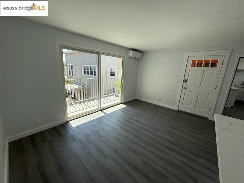 4057 Brant Street, Unit 8 San Diego, CA 92103 - Photo 8 of 17 a view of an empty room with wooden floor and a window