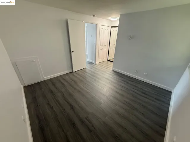 a view of hallway with wooden floor