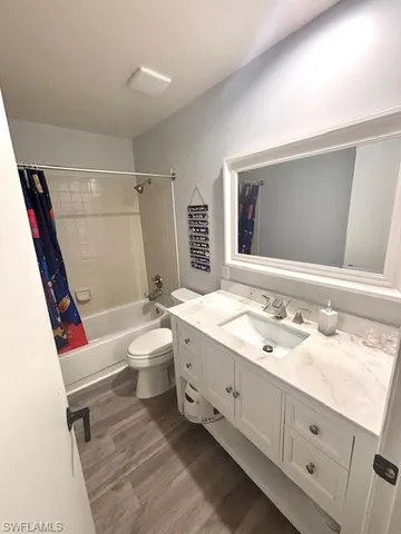 a bathroom with a sink a toilet and shower a mirror