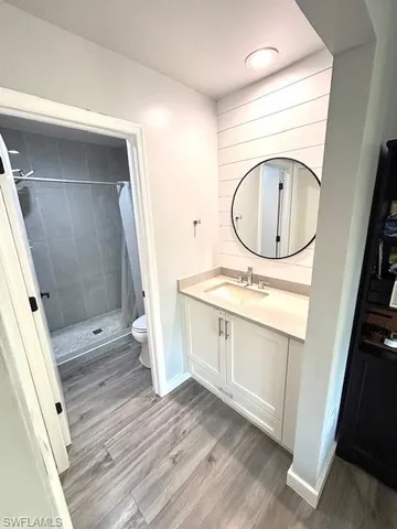 a bathroom with a sink a toilet and a mirror