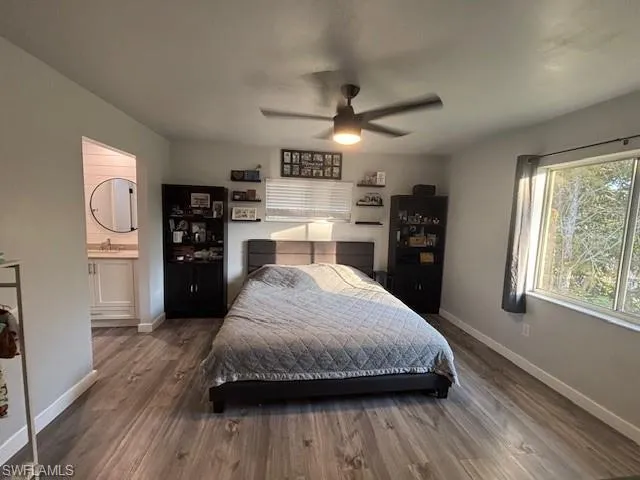 a spacious bedroom with a bed and a wooden floor