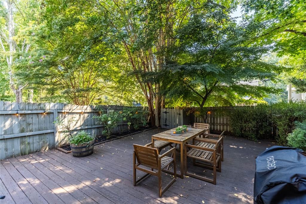 1601 Defoors Landing Northwest Atlanta, GA 30318 - Photo 47 of 48 a view of a patio with table and chairs potted plants with wooden fence