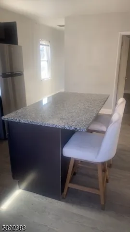 a view of a room with a table and chairs