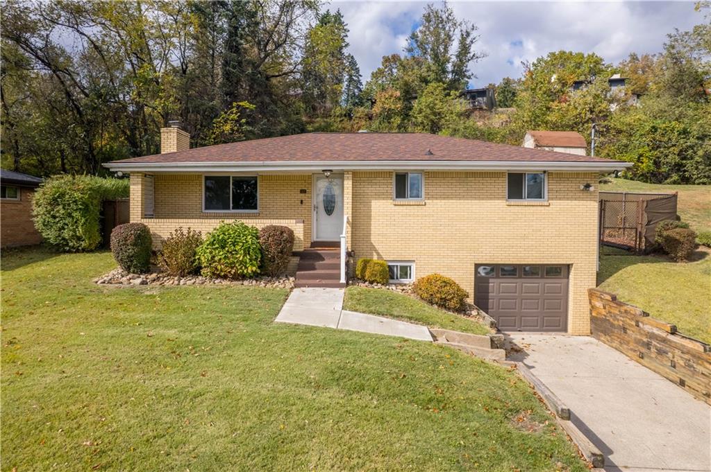 127 George Street Turtle Creek, PA 15145 - Photo 1 of 34 a front view of a house with a yard and garage