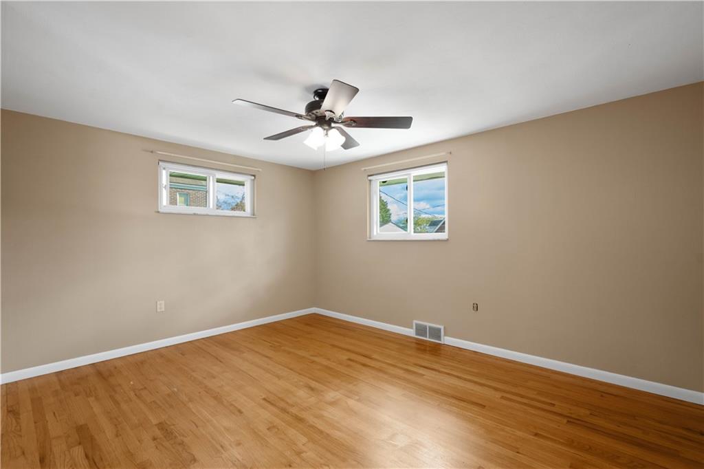 127 George Street Turtle Creek, PA 15145 - Photo 12 of 34 a view of a big room with wooden floor and a ceiling fan