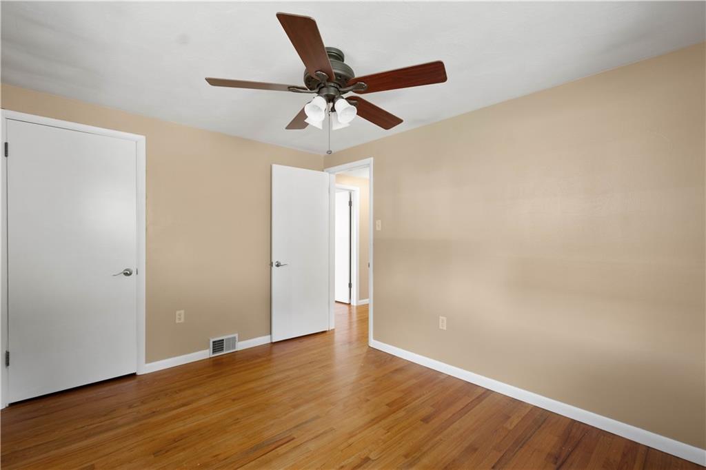 127 George Street Turtle Creek, PA 15145 - Photo 15 of 34 an empty room with wooden floor a ceiling fan and wooden floor