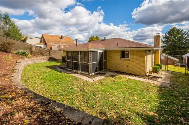a view of a backyard with a garden and entertaining space