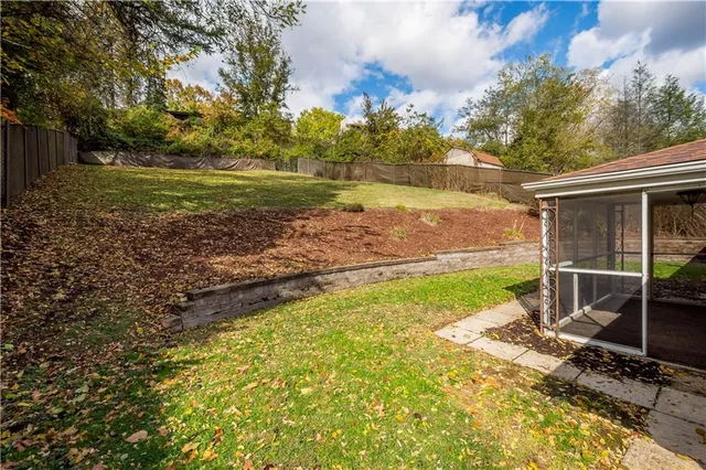 a view of a house with a yard and sitting area