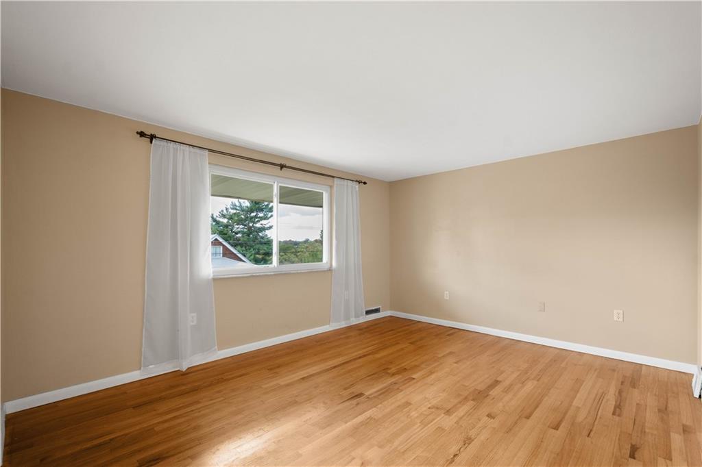 127 George Street Turtle Creek, PA 15145 - Photo 3 of 34 a view of empty room with wooden floor and fan