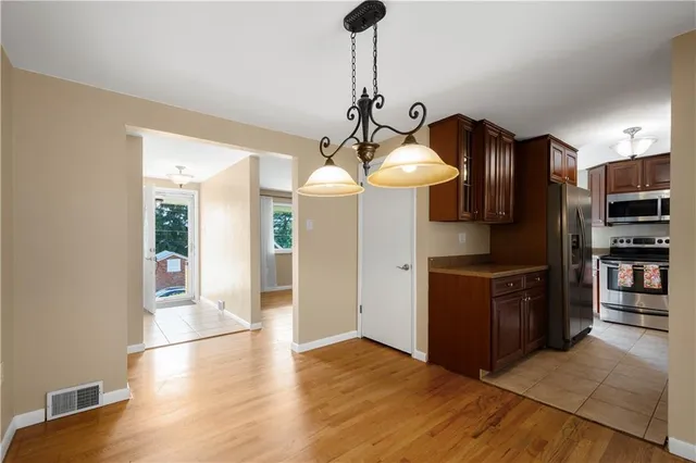 a kitchen with stainless steel appliances granite countertop a refrigerator and a sink