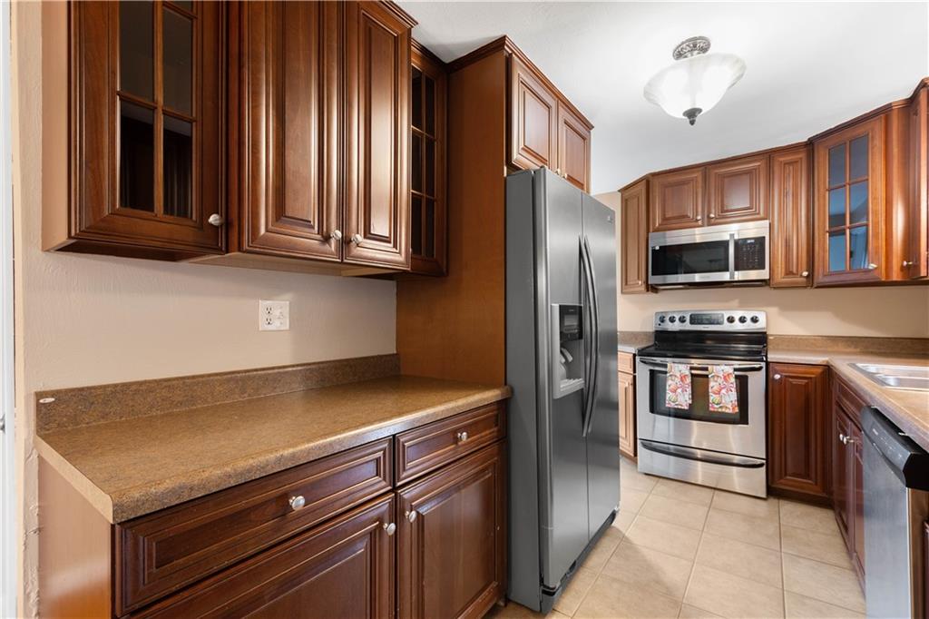 127 George Street Turtle Creek, PA 15145 - Photo 7 of 34 a kitchen with granite countertop stainless steel appliances and wooden cabinets