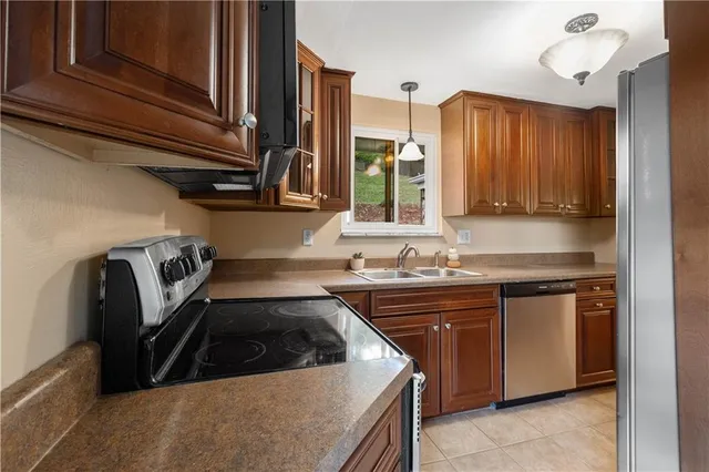 a kitchen with a sink a stove and cabinets