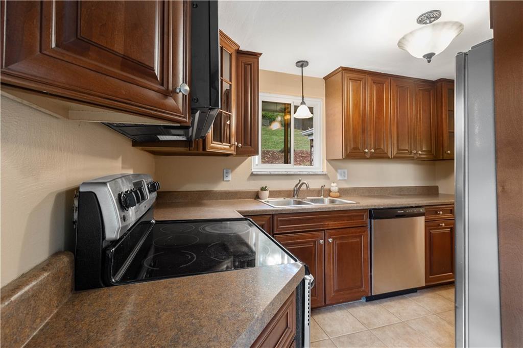 127 George Street Turtle Creek, PA 15145 - Photo 8 of 34 a kitchen with a sink a stove and cabinets