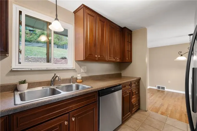 a kitchen with stainless steel appliances granite countertop a sink and a cabinets