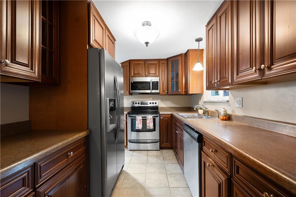 127 George Street Turtle Creek, PA 15145 - Photo 10 of 34 a kitchen with stainless steel appliances granite countertop a refrigerator stove and sink