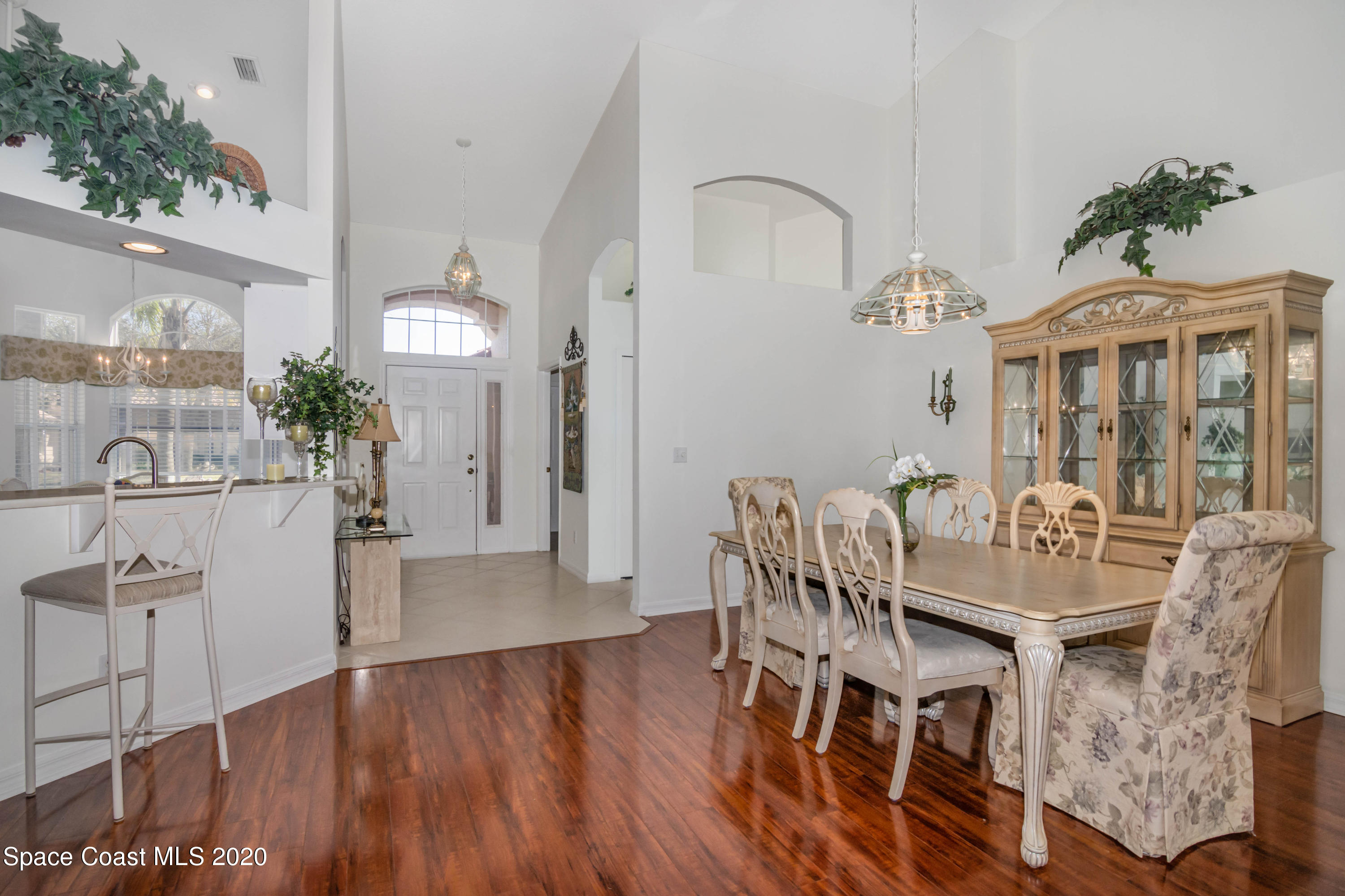 421 Shell Cove Drive Melbourne, FL 32940 - Photo 12 of 23 a view of a dining room with furniture and wooden floor