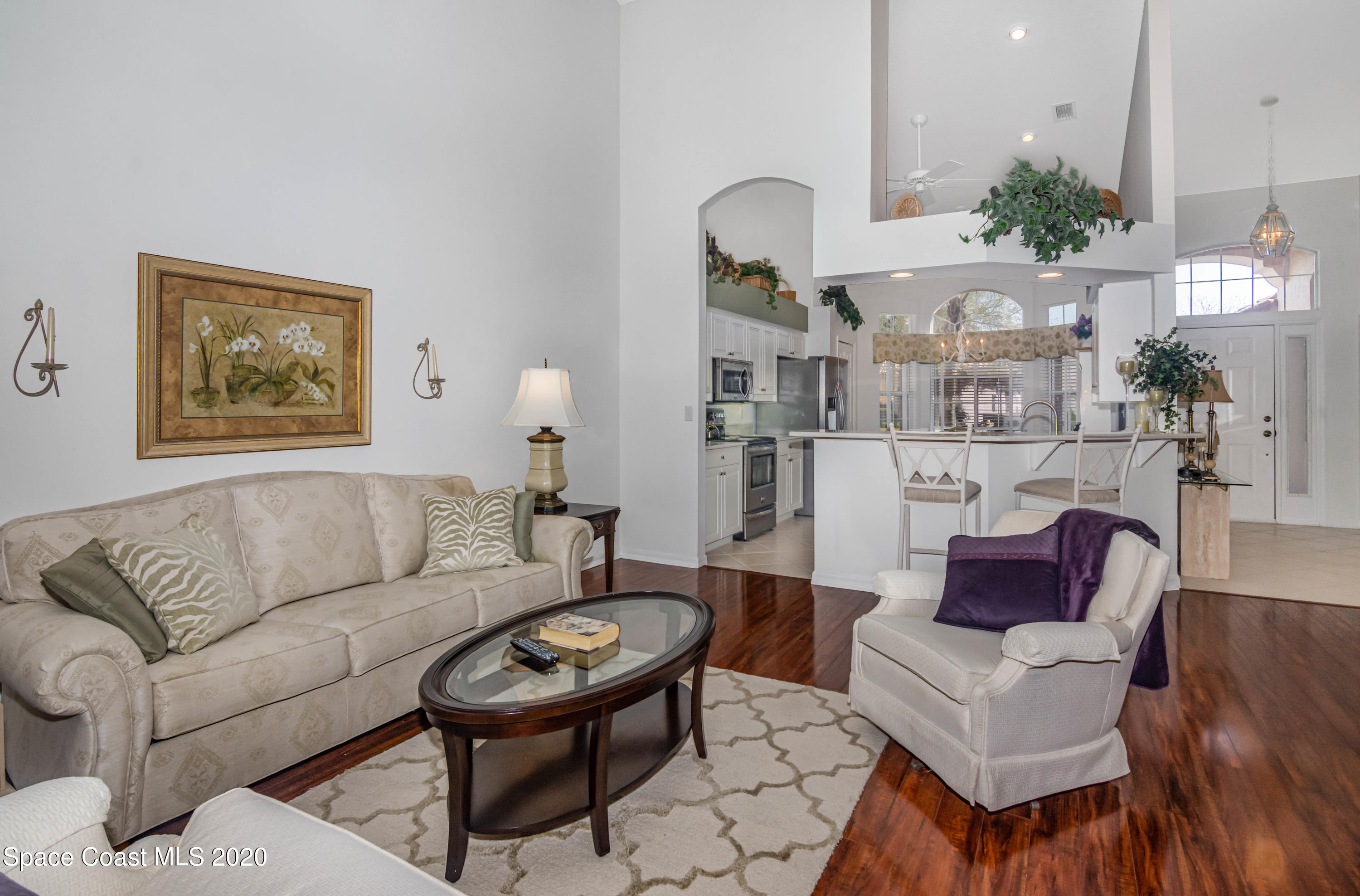 421 Shell Cove Drive Melbourne, FL 32940 - Photo 14 of 23 a living room with furniture a rug and a painting