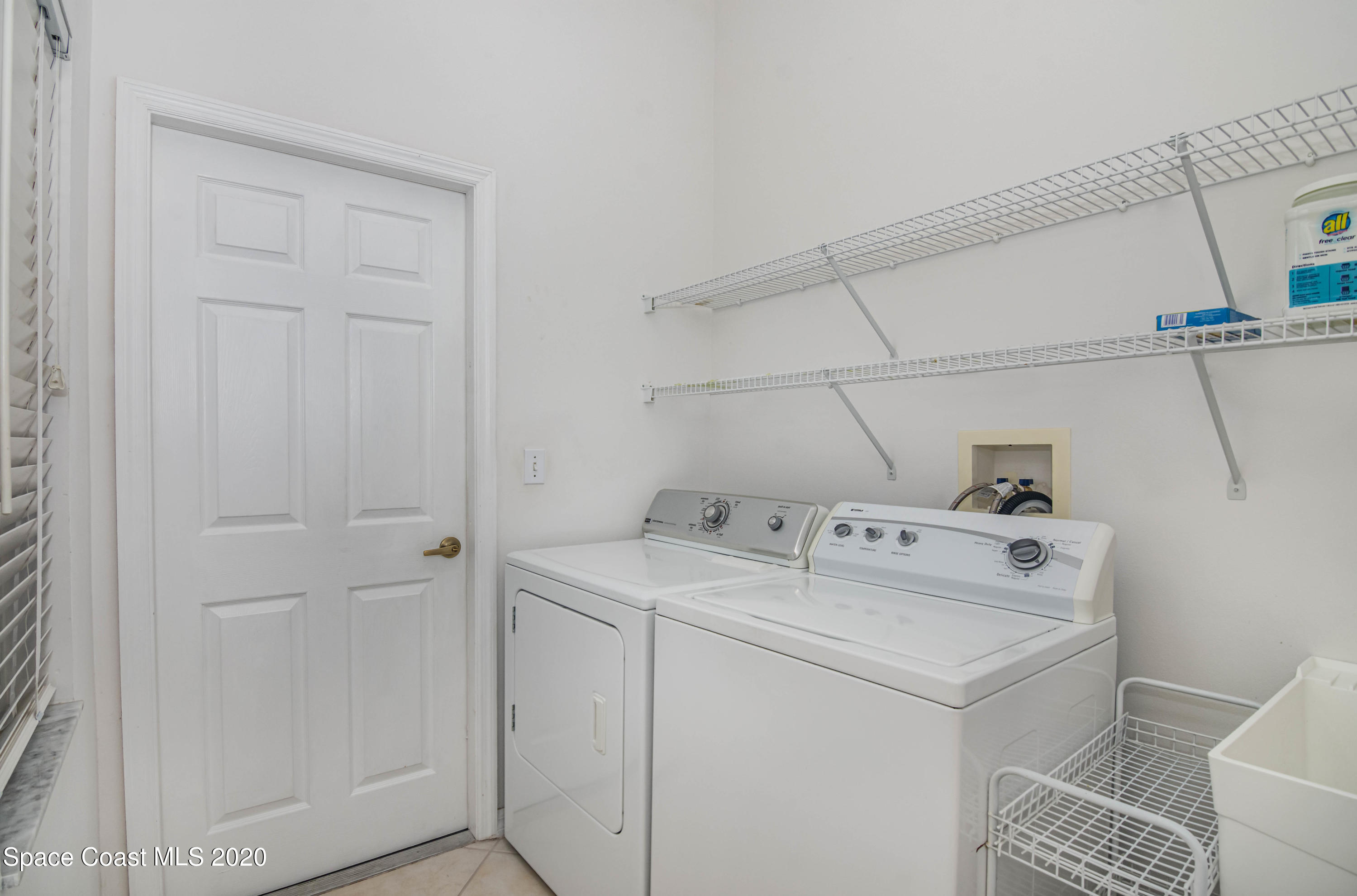 421 Shell Cove Drive Melbourne, FL 32940 - Photo 19 of 23 a utility room with dryer and washer