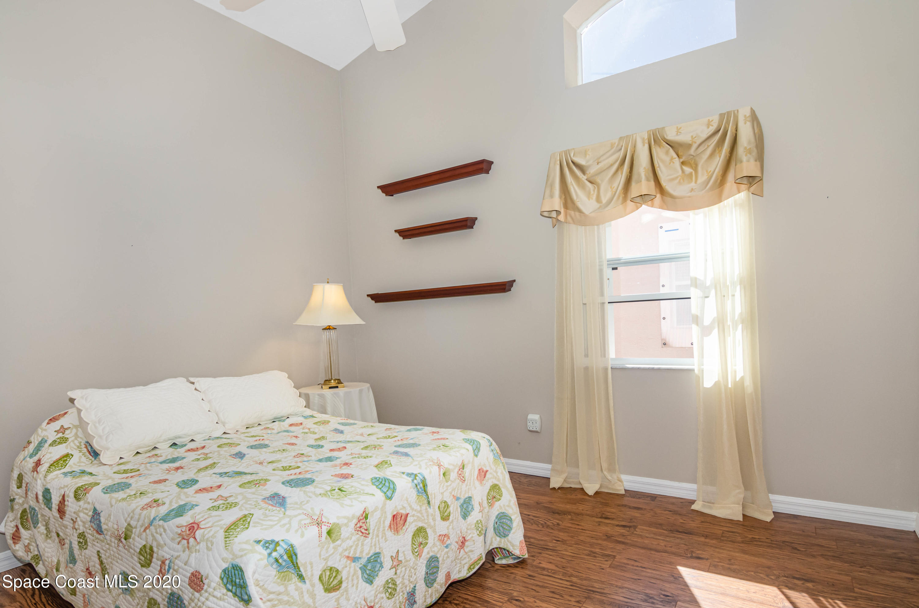 421 Shell Cove Drive Melbourne, FL 32940 - Photo 22 of 23 a bedroom with a bed and a window