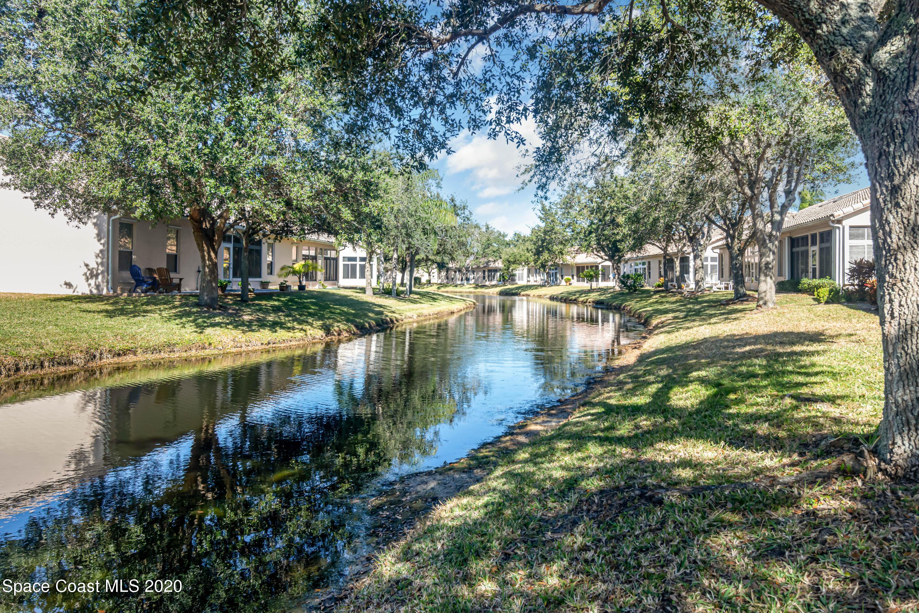 421 Shell Cove Drive Melbourne, FL 32940 - Photo 4 of 23 a view of a lake with houses