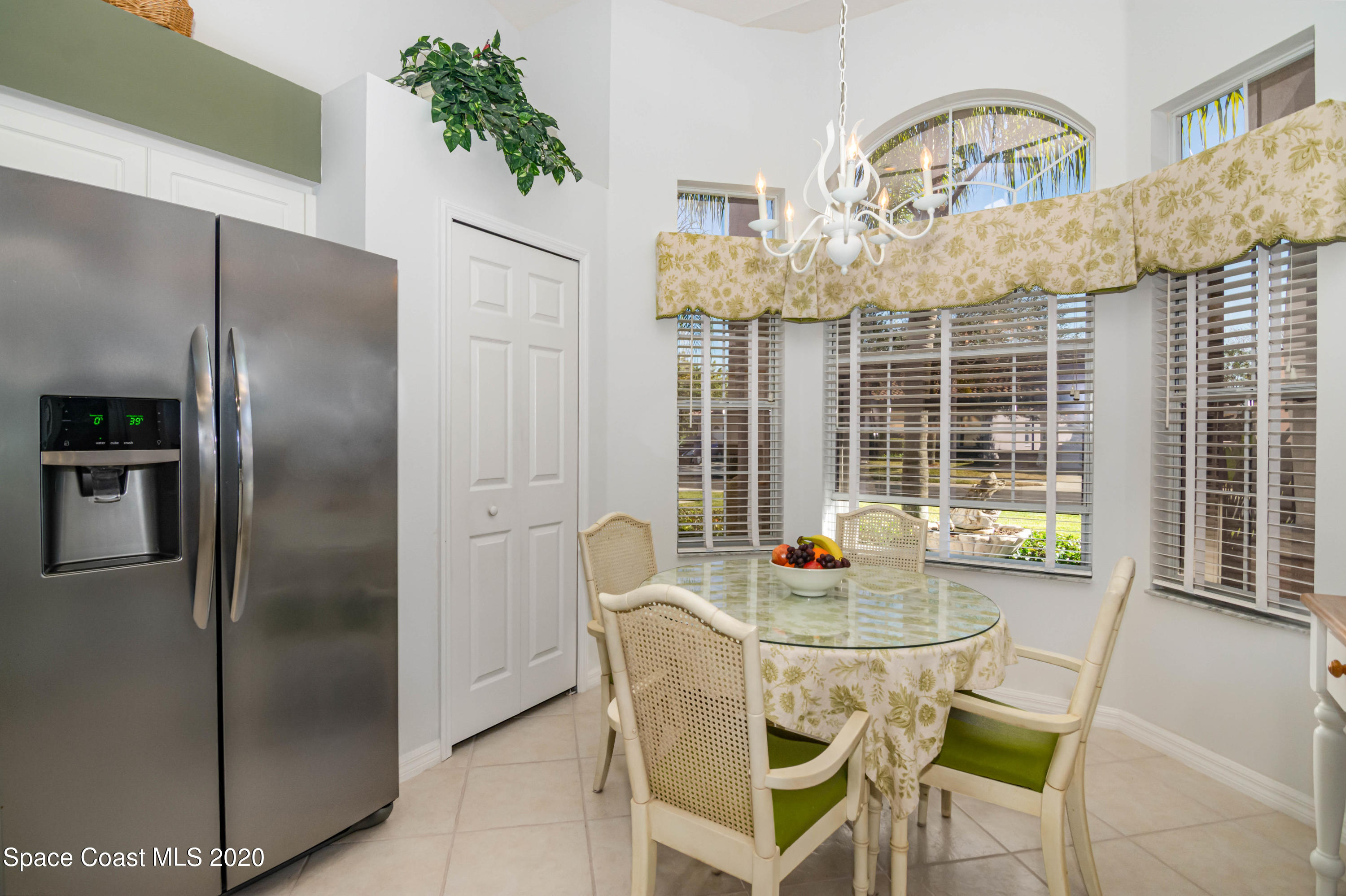 421 Shell Cove Drive Melbourne, FL 32940 - Photo 7 of 23 a dining room with furniture a chandelier and wooden floor