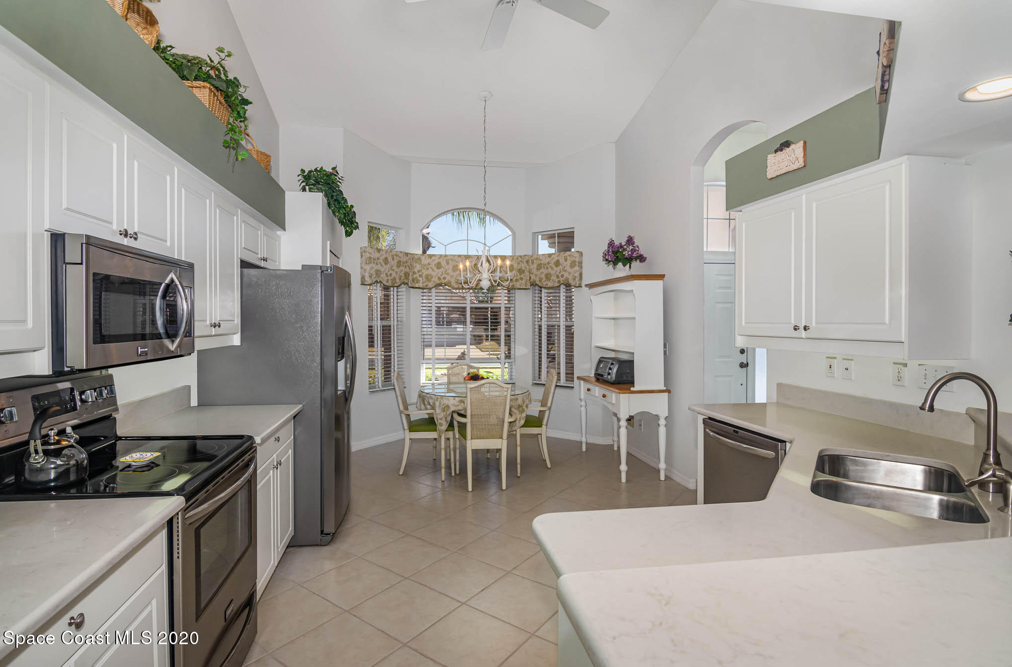 421 Shell Cove Drive Melbourne, FL 32940 - Photo 10 of 23 a kitchen with stainless steel appliances granite countertop a sink a stove and a refrigerator