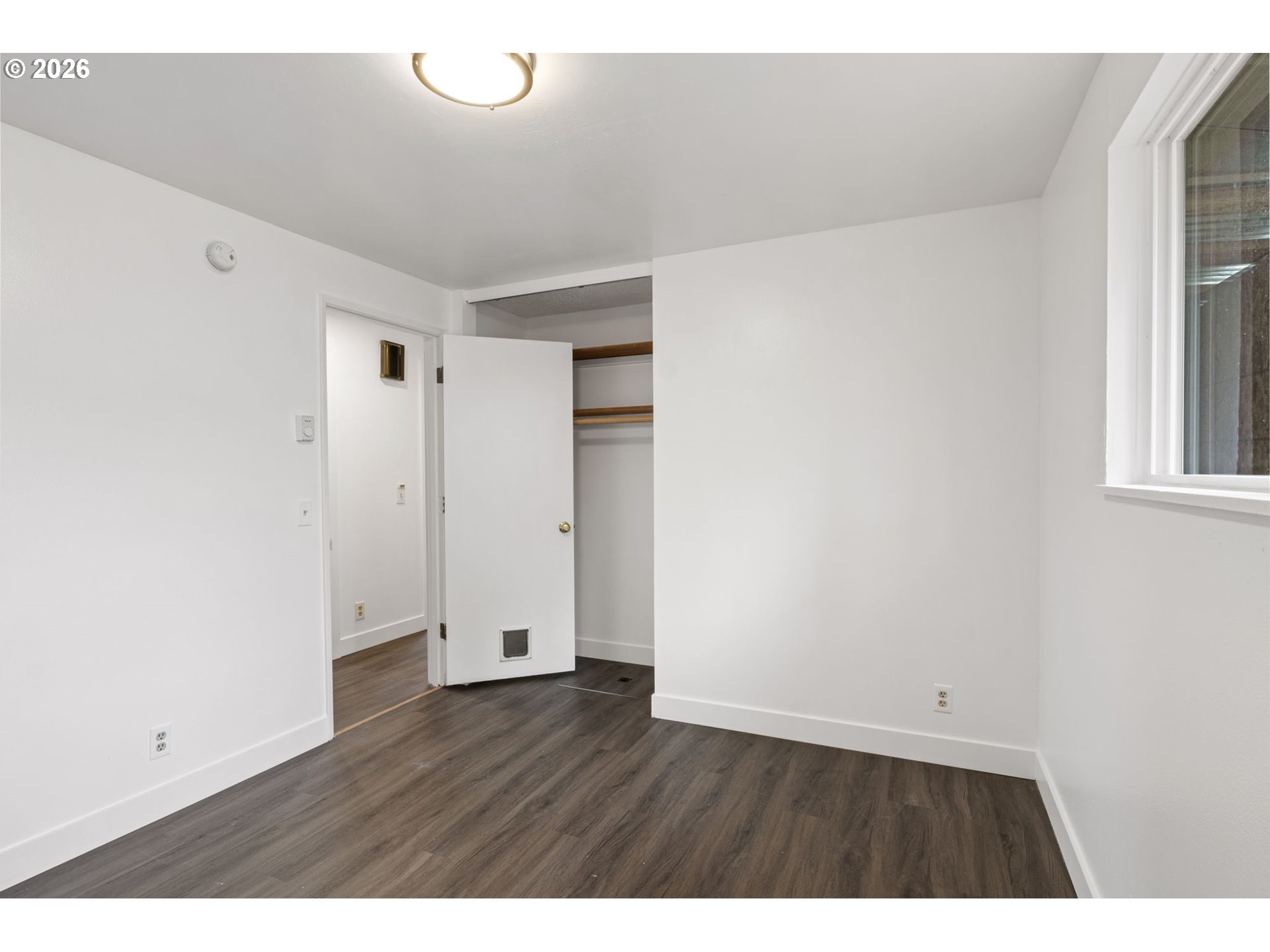 1885 Churchill Street Eugene, OR 97405 - Photo 26 of 45 a view of an empty room with wooden floor and a window