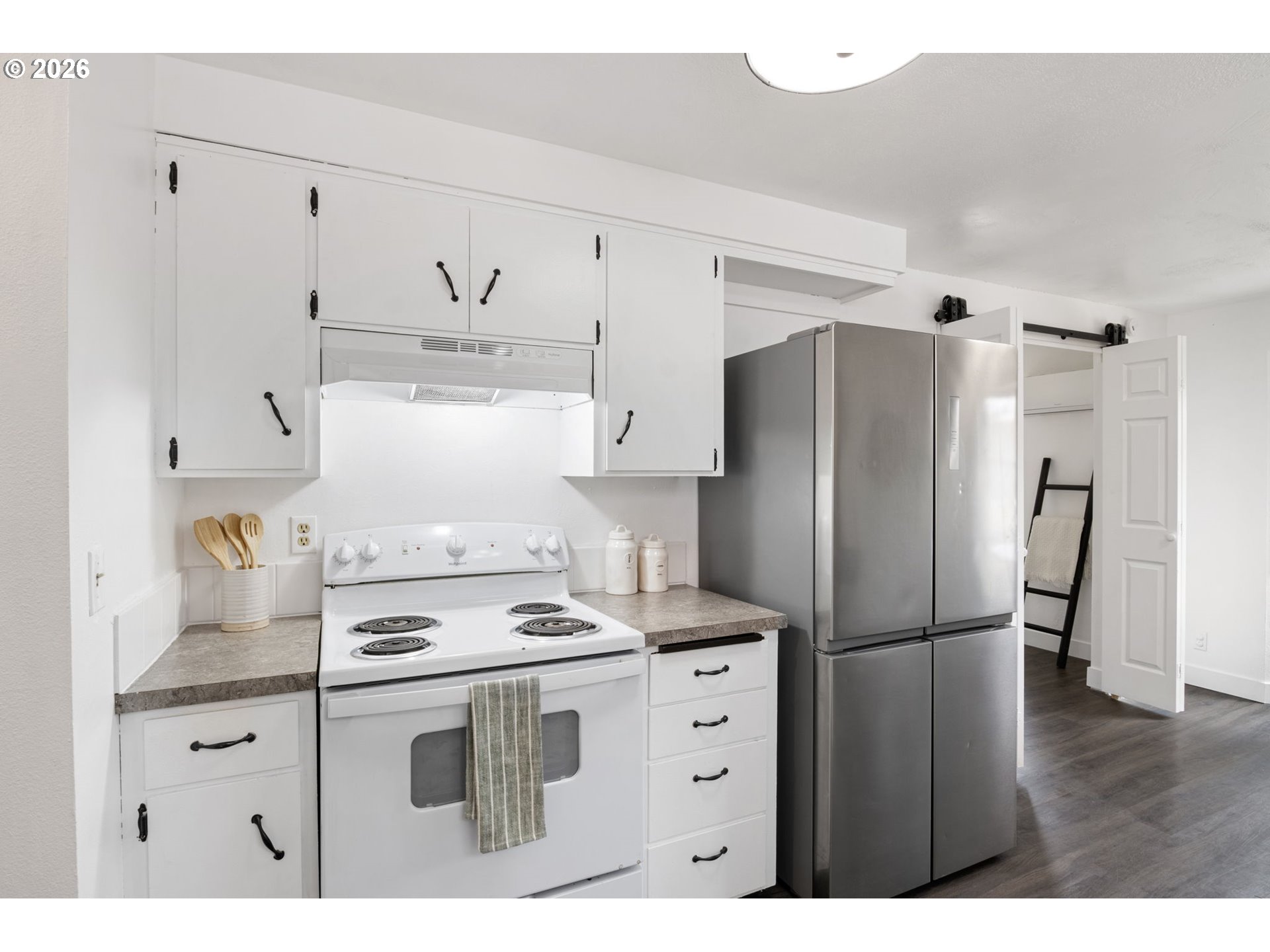 1885 Churchill Street Eugene, OR 97405 - Photo 9 of 45 a kitchen with refrigerator cabinets and wooden floor