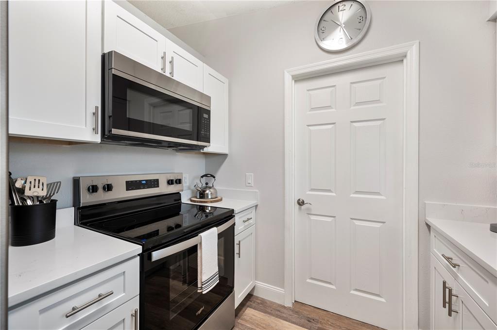 1106 Lakewood Road Lakeland, FL 33805 - Photo 11 of 27 a kitchen with a stove and a microwave