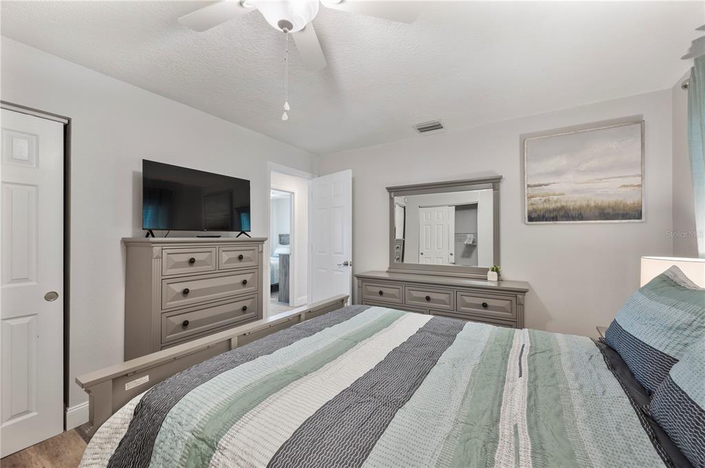 1106 Lakewood Road Lakeland, FL 33805 - Photo 14 of 27 a bedroom with a bed and a flat screen tv