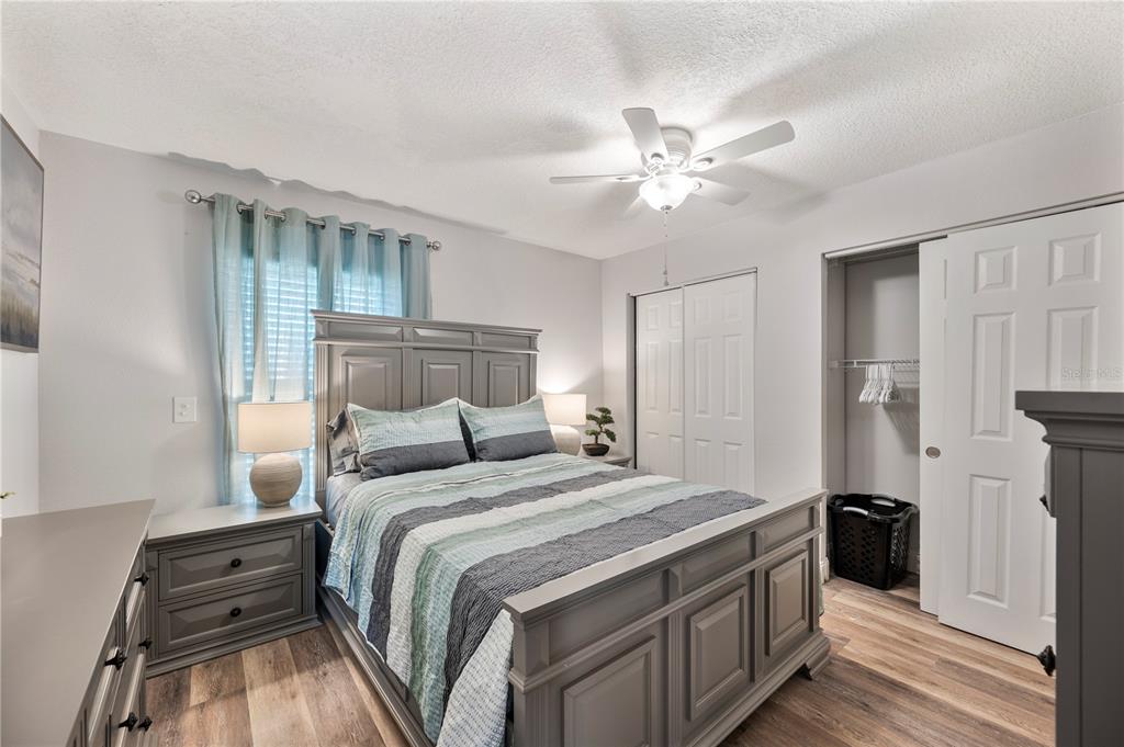 1106 Lakewood Road Lakeland, FL 33805 - Photo 15 of 27 a bedroom with a bed and a chandelier