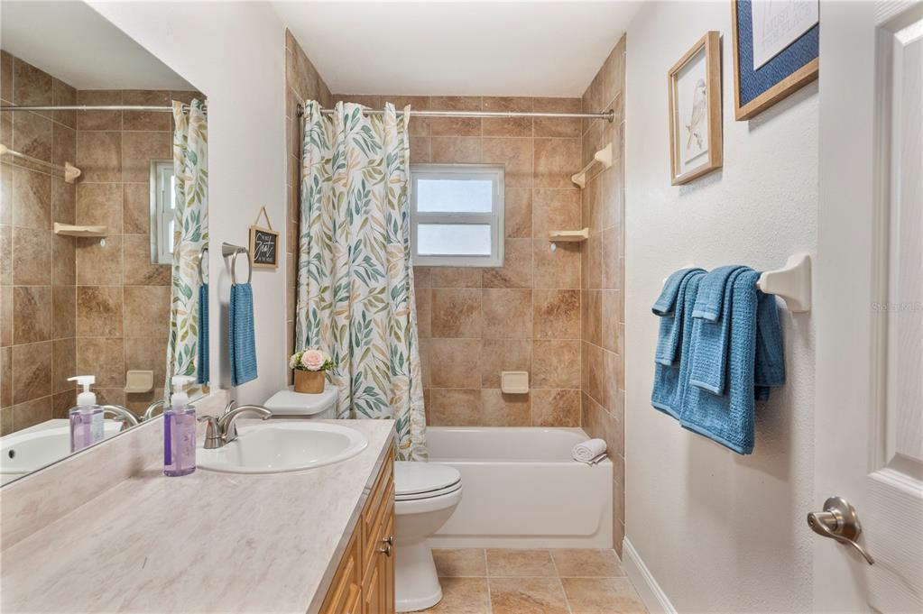 1106 Lakewood Road Lakeland, FL 33805 - Photo 16 of 27 a bathroom with a granite countertop bathtub shower and a sink
